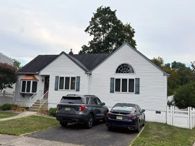 Single-story white cape-style house in Haddon Heights, NJ before a whole-home renovation