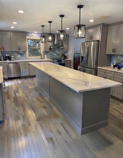 Remodeled Cherry Hill, NJ kitchen with gray shaker cabinets and a quartz waterfall island