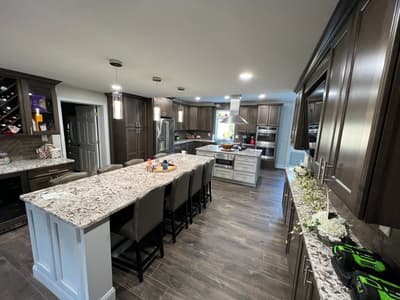 Custom kitchen renovation with dark wood cabinetry by KRidge Construction