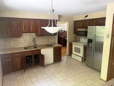 Dated Cherry Hill, NJ kitchen with dark wood cabinets and tile backsplash before remodeling